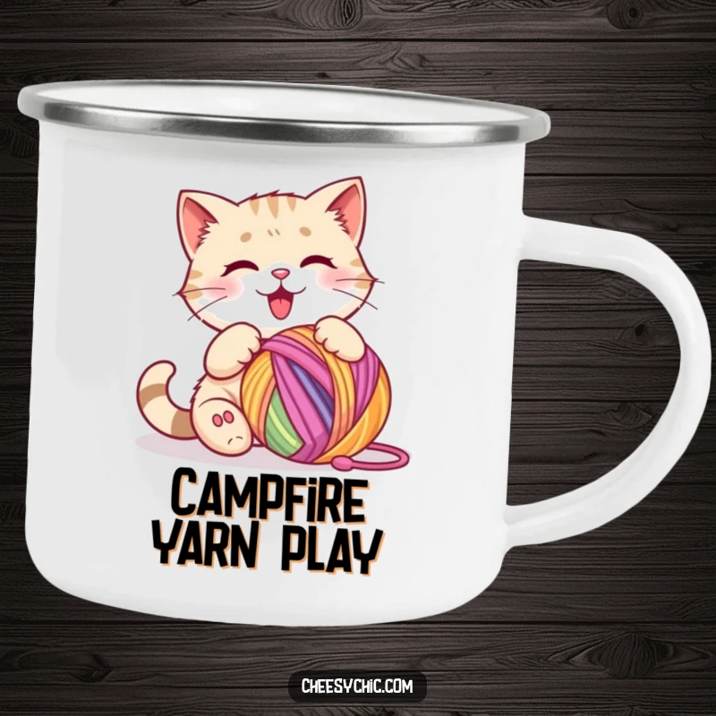 Funny camping mug illustrating a cute cat character happily batting a colorful ball of yarn, ready for adventure.