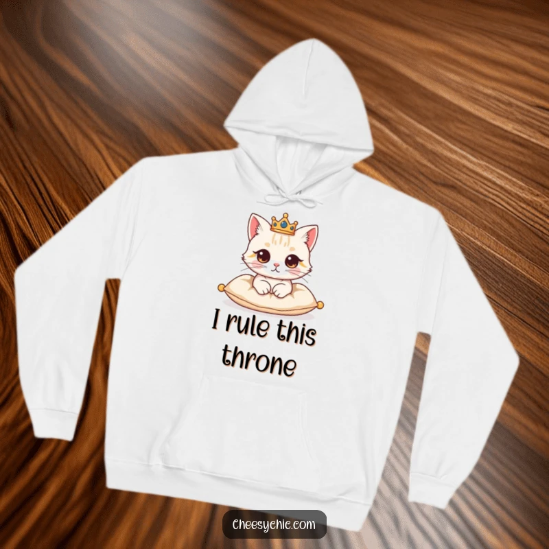 Funny hoodie illustrating a cute cat character with a small crown, exuding majesty while resting elegantly on a cushion.