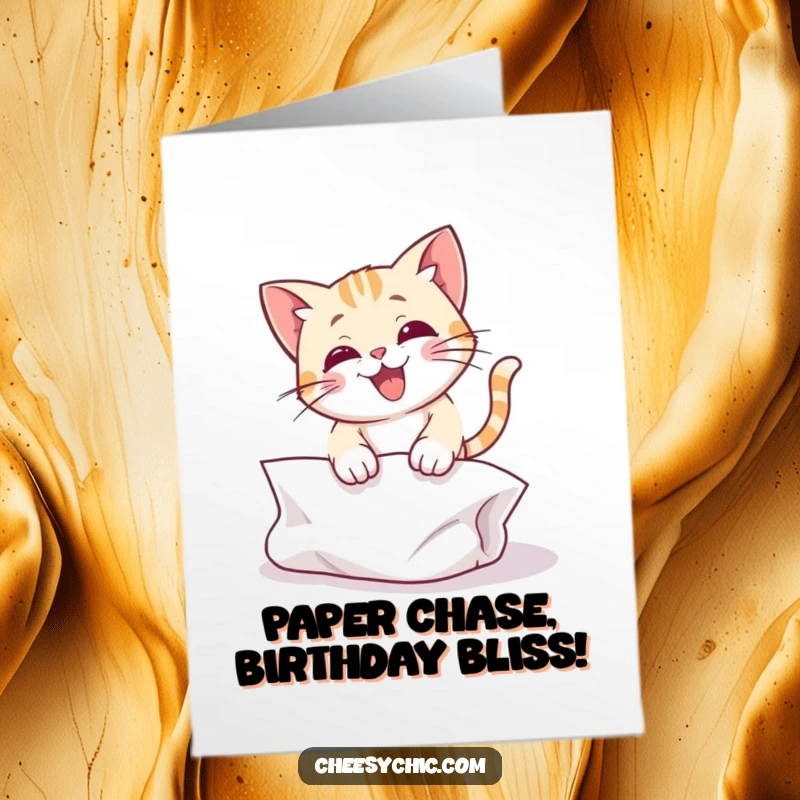 Funny Free Printable Birthday Card: Cat joyfully pouncing on crumpled paper, ready for a playful celebration.