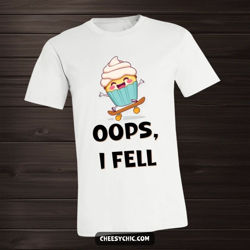 Funny t-shirt graphic of a happy anthropomorphic cupcake comically falling off a tiny skateboard, arms flailing playfully.