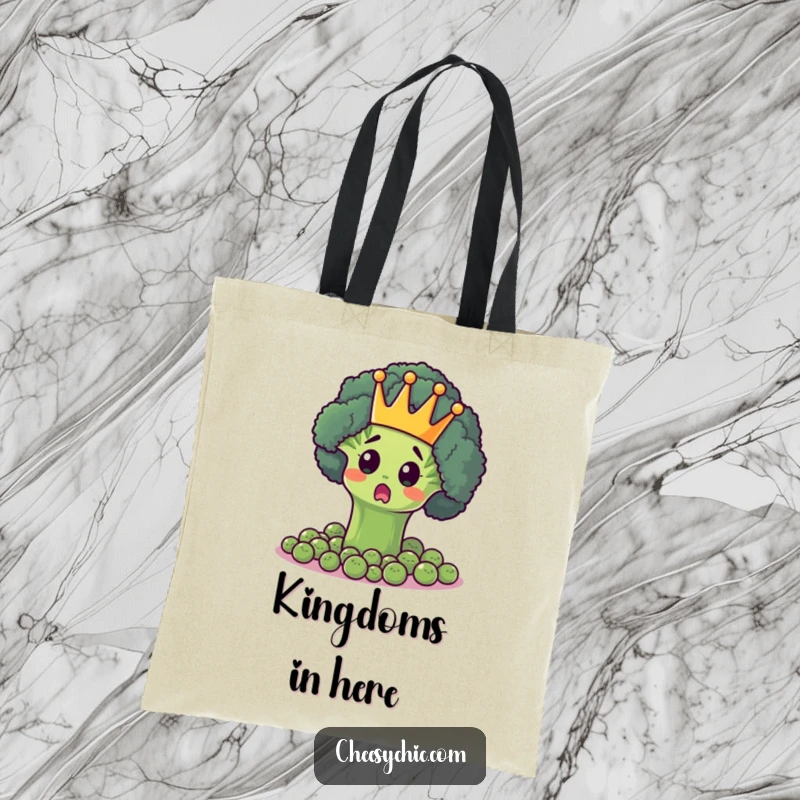 Funny tote bag featuring a surprised broccoli floret in a crown, ruling over a kingdom of peas, perfect for everyday use.